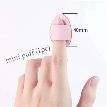 Mini puff applicator shown on a finger, measuring 40mm, for easy makeup application.